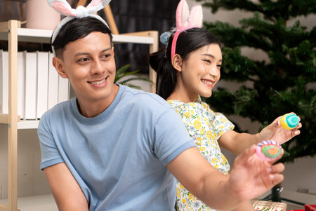 A young couple is designing and painting Easter eggs on Easter
