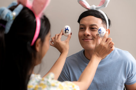 A young couple is designing and painting Easter eggs on Easter