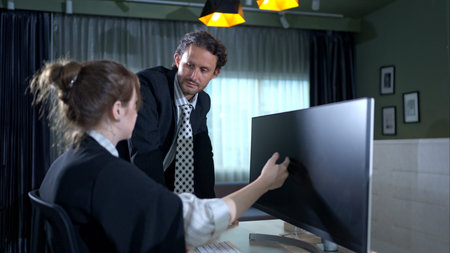 In the office, two businessmen and women discuss and exchange idea and give advice to each other to...