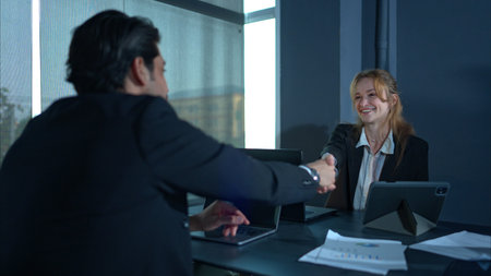In the office, two businessmen and women discuss and exchange idea and give advice to each other to...