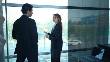 In the office, two businessmen and women discuss and exchange idea and give advice to each other to...