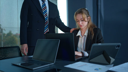 In the office, two businessmen and women encourage each other after a mistake in their work
