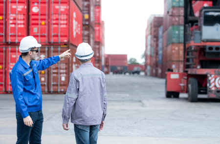 Engineers and technicians supervise and inspect the delivery of containers at container...