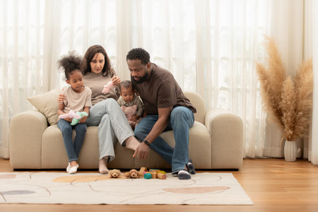 Parents and children relax during their holiday at homeの写真素材
