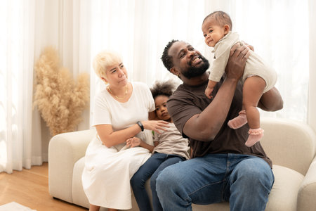 Parents and children relax during their holiday at homeの写真素材