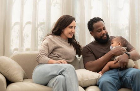 A little boy sleeps in his father's armsの写真素材