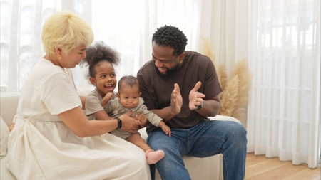 Parents and children relax during their holiday at homeの写真素材