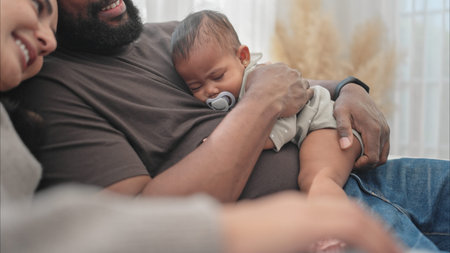 A baby sleeps in his father's arms