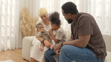 Parents and children relax during their holiday at homeの写真素材