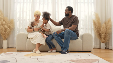 Parents and children relax during their holiday at homeの写真素材