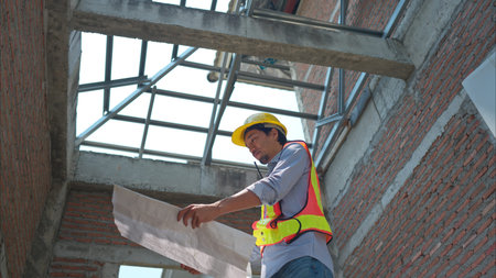 Portrait of engineers inspect and assess the residential home construction site's progress