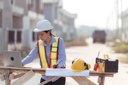 Portrait of engineers inspect and assess the residential home construction site's progress