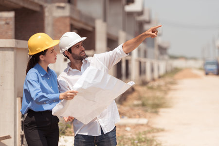 Architects and engineers work together to assess the residential home construction site's progress
