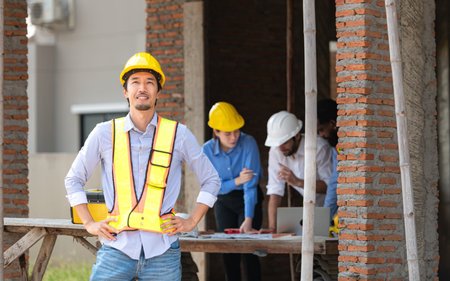 Portrait of engineers work together to assess the residential home construction site's progressの写真素材