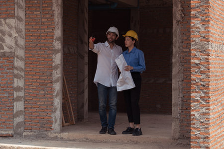 Architects and engineers work together to assess the residential home construction site's progressの写真素材