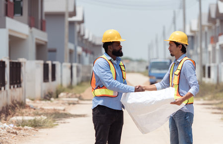 Architects and engineers work together to assess the residential home construction site's progressの写真素材