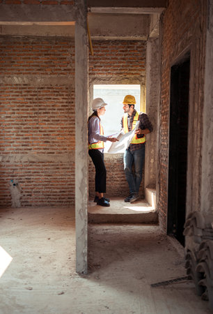 Architects and engineers work together to assess the residential home construction site's progress