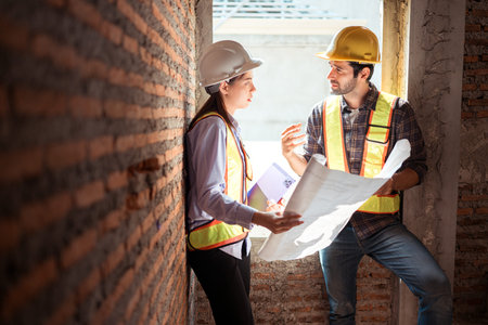 Architects and engineers work together to assess the residential home construction site's progress