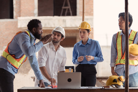 Group of architects and engineers work together to assess the residential home construction site's progressの写真素材
