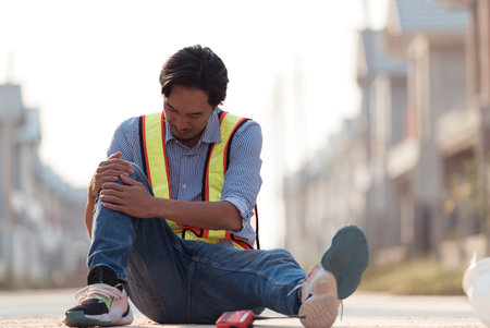 Coworkers provided first aid to a worker who had an accident on his leg while he was works a house's construction siteの写真素材