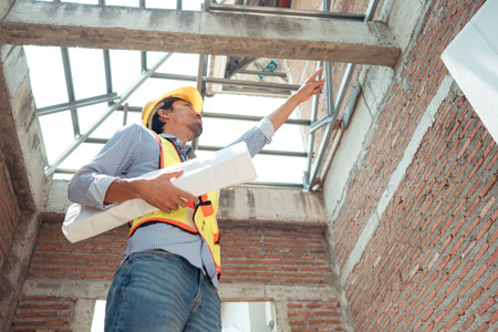Portrait of engineers inspect and assess the residential home construction site's progress