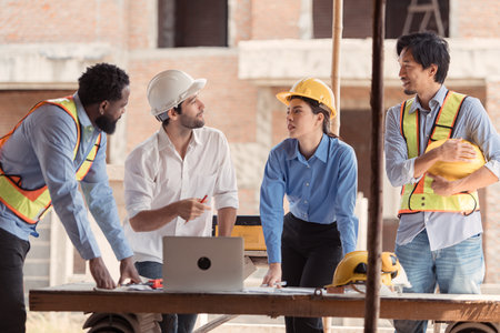 Group of architects and engineers work together to assess the residential home construction site's progressの写真素材