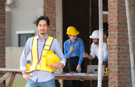 Portrait of engineers work together to assess the residential home construction site's progressの写真素材