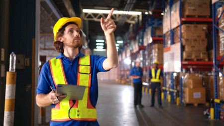 Portrait of warehouse workers are reviewing the list of items based on the documentationの写真素材