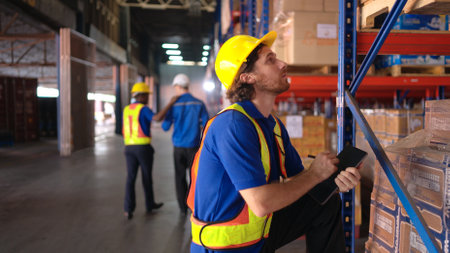Portrait of warehouse workers are reviewing the list of items based on the documentationの写真素材