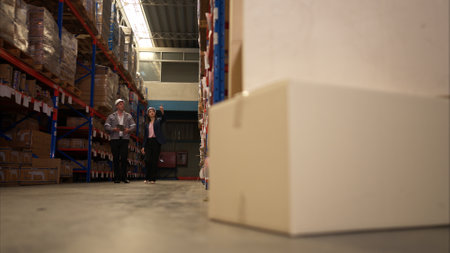 Business woman and warehouse workers are reviewing the list of items based on the documentationの写真素材