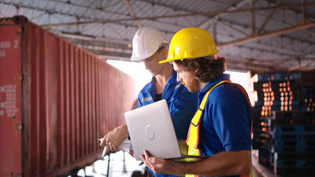 Warehouse workers are reviewing the list of items based on the documentationの写真素材