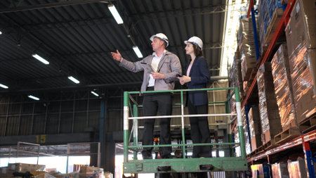 Business woman and warehouse workers are reviewing the list of items based on the documentationの写真素材