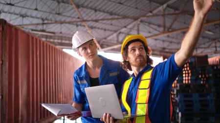 Warehouse workers are reviewing the list of items based on the documentationの写真素材