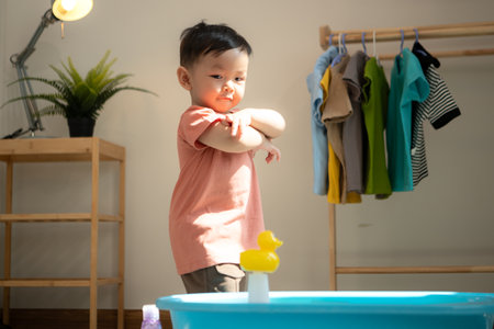 Little boy playing before bathing himの写真素材