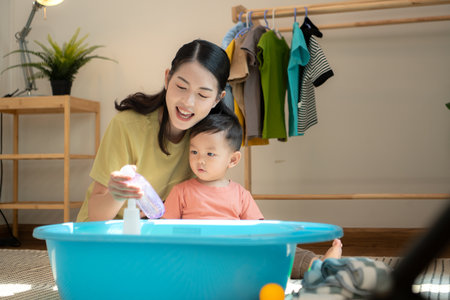 Little boy with breakfast with mom feeding him before bathingの写真素材
