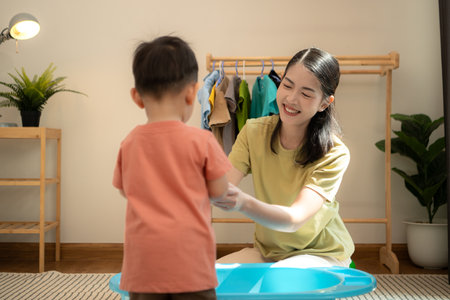 Little boy with mom feeding him before bathing himの写真素材