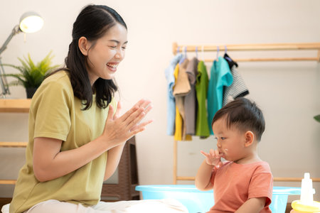 Little boy with breakfast with mom feeding him before bathingの写真素材