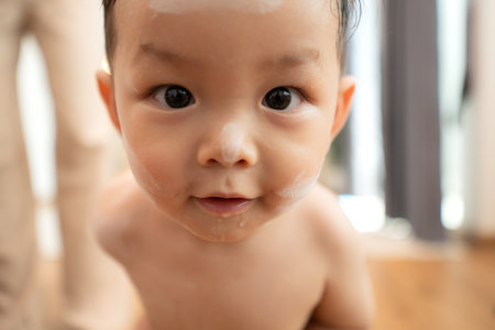 Mom and little child with taking a shower and dressing at home in the morningの写真素材