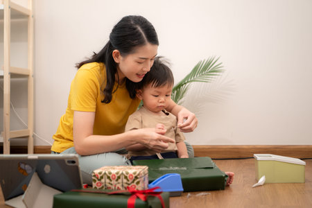 While in vacation at home, a mother gift wrap with little kid