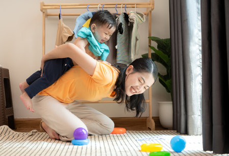 Mom and little child playing at home in the morningの写真素材