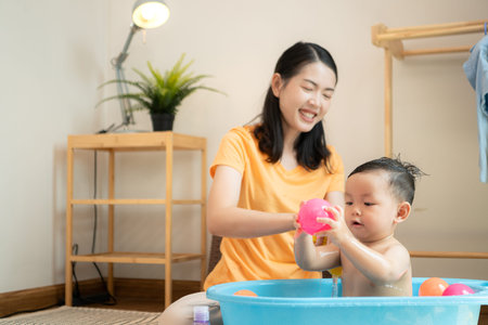 Mom and little child with taking a shower and dressing at home in the morning