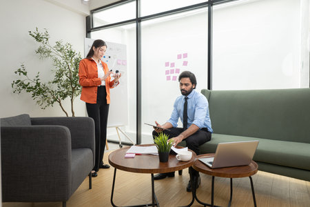 In a contemporary office, two young entrepreneurs are on a mission to generate ideas and establish a...