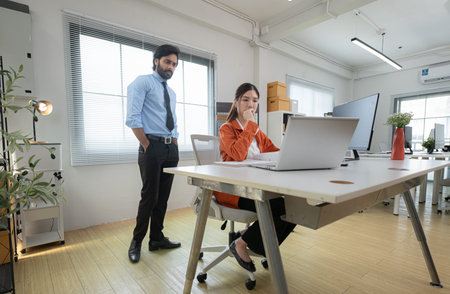 In a contemporary office, two young entrepreneurs are on a mission to generate ideas and establish a...