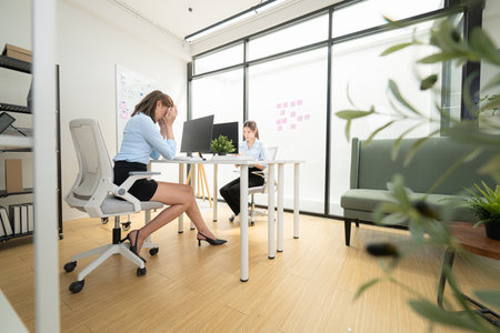 In a contemporary office, two young woman entrepreneurs are on a mission to generate ideas and establish a business projectの写真素材