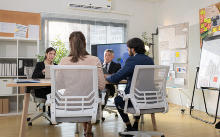 In a contemporary office, a group of senior executives with a mission to approve new projects and monitor the progress of business projectsの写真素材