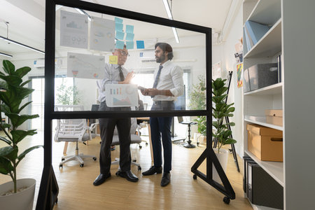 In a contemporary office, a group of senior executives with a mission to approve new projects and monitor the progress of business projectsの写真素材