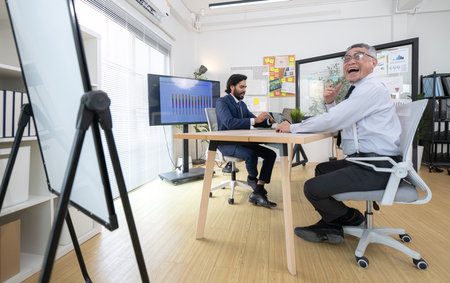 In a contemporary office, two senior executives with a mission to brainstorm and monitor the progress of a business projectの写真素材