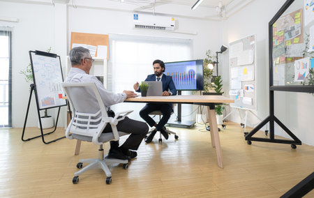 In a contemporary office, two senior executives with a mission to brainstorm and monitor the progress of a business projectの写真素材