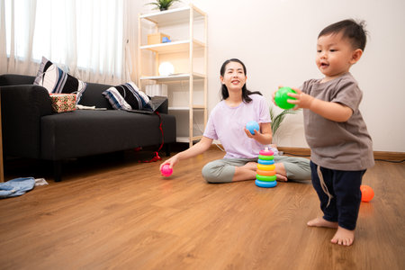 While in vacation at home, a mother engages in activities with little kidの写真素材
