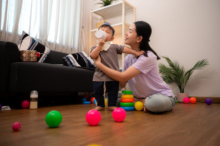 While in vacation at home, a mother engages in activities with little kid